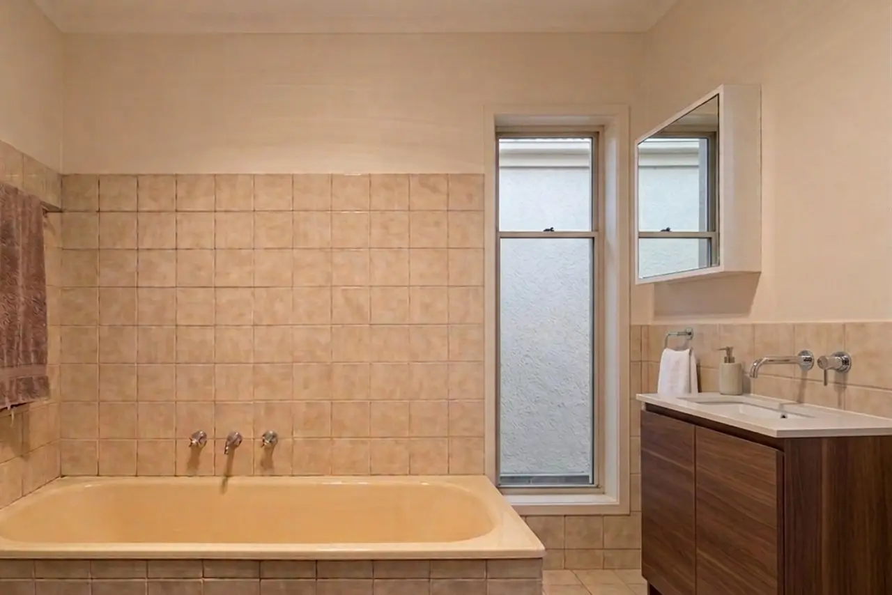 The bathroom before: dark and aged